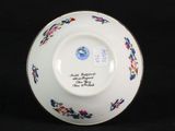 a white plate with blue and red flowers on it