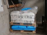 a pallet full of water bottles and a television in a room