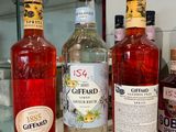 several bottles of alcohol are lined up on a counter