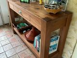 a wooden table with a basket on top of it