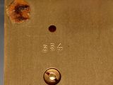 a gold clock with numbers on it on a table