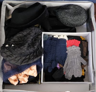 a suitcase filled with clothes and gloves on the floor