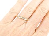 a woman ' s hand with a diamond ring on it