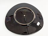 a black plate with a clock on it on a white surface