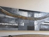 a painting on the wall above a bed in a room