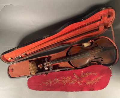 a violin in a case on a table with a red cloth