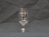 a wine glass that is sitting on a table
