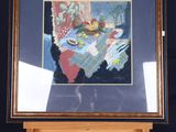 framed picture of a painting on a easel with a black background