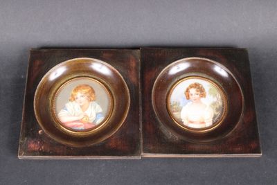 pair of miniature porcelain portraits of children in a wooden box