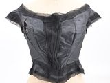 black satin corset top with ruffles on a mannequin dummy