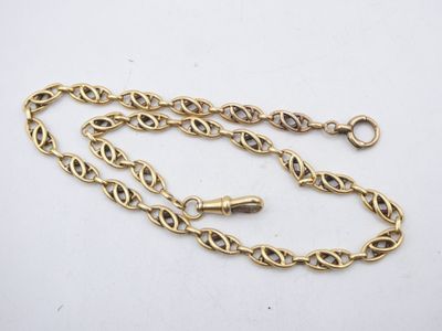 a close up of a gold chain on a white surface