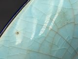 a close up of a blue vase with a cracky surface
