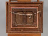 an old wooden box with a rope hanging from the top of it