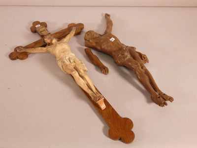 two wooden crucifies laying on a white surface