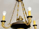 a chandelier that has three lights hanging from it ' s ceiling