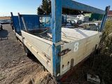 a blue truck that is sitting in the dirt