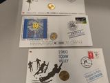 three different stamps and a coin are on a table