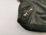 a black purse with a chain hanging from it ' s side