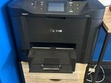 the printer is sitting on top of the cabinet in the room