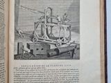 an open book with a drawing of a machine on it