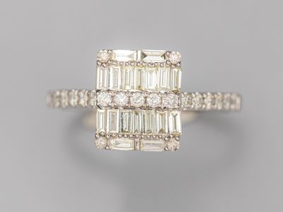 a diamond and white gold ring with baguets of diamonds
