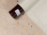 a bottle of wine sitting on the floor next to a roll of paper