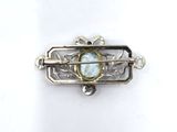 an image of a brooch with a stone in the center