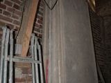 a ladder leaning against a brick wall in a room