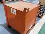 a large orange box sitting on a pallet in a warehouse