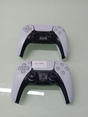 two video game controllers that are sitting on a table