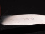 a close up of a knife on a black surface