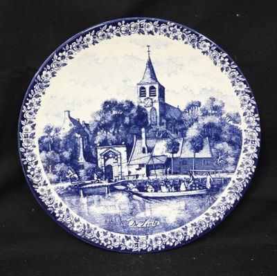 a blue and white plate with a picture of a church on it