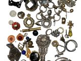 a pile of assorted jewelry on a white surface