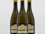 trois bouteilles de vin posées l'une à côté de l'autre sur une table