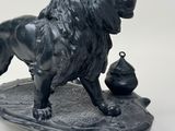 a statue of a lion that is standing on a table