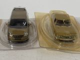 two small cars in plastic bags on a table