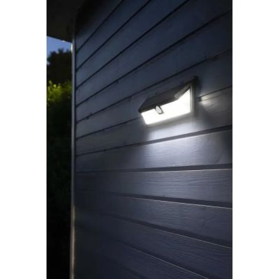 a close up of a light on the side of a building