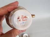 a person holding a small cup with a picture on it