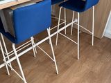 a picture of a kitchen table with four blue chairs