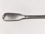 a close up of a spoon on a white surface with a white background
