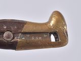 a wooden pipe cutter with a brass handle on a white surface