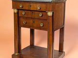 an old wooden table with two drawers and a marble top