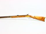 an old rifle on a white surface with a white background