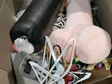 a cardboard box filled with assorted items and a stuffed animal