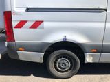 a silver van with a red stripe on the side of it