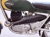 a green and yellow motorcycle parked on the side of the road