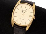 an image of a gold watch on a black cloth
