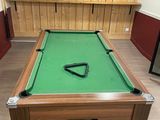 a pool table with a green cloth on it