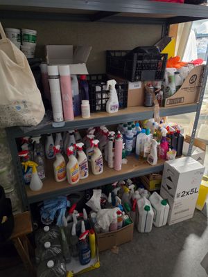 de nombreuses bouteilles de produits d'entretien sur les étagères de la pièce