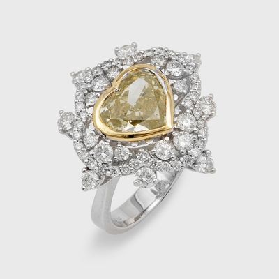 a diamond and gold ring with a heart shaped center